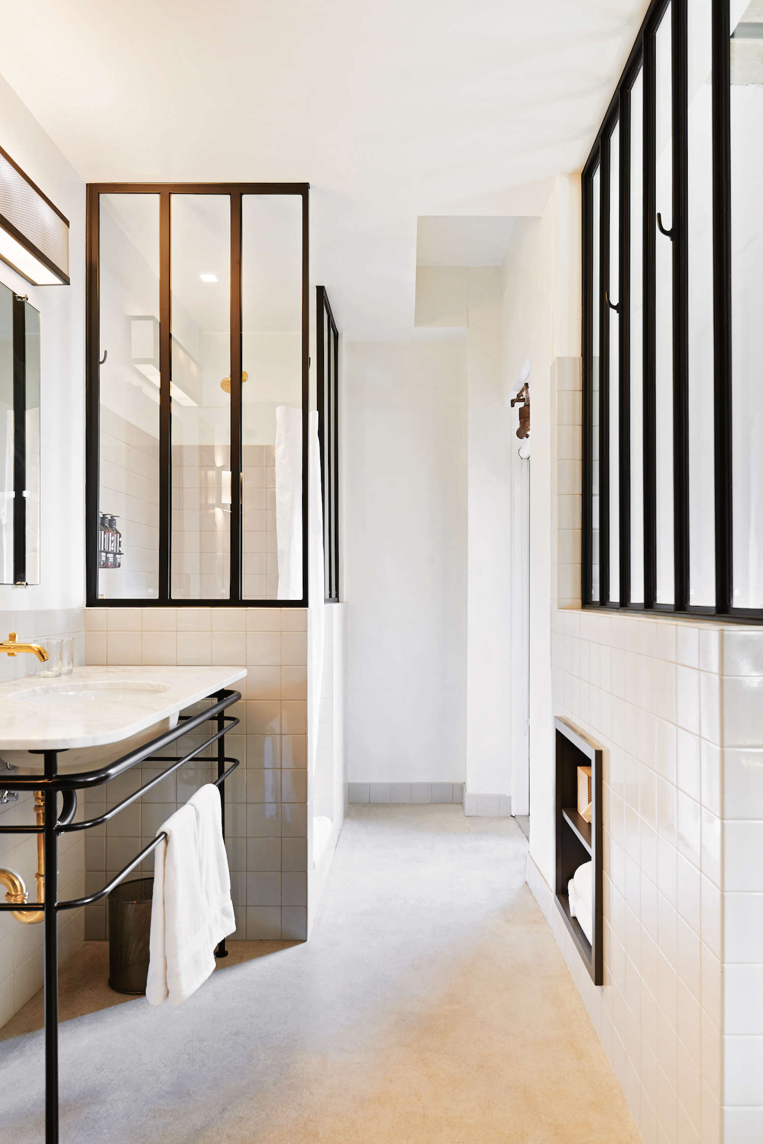 white bathroom with black steel interior windows 18