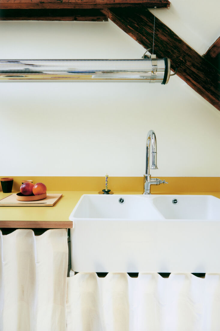 the kitchen has a plywood and formica counter with exposed wood edging and a wa 20