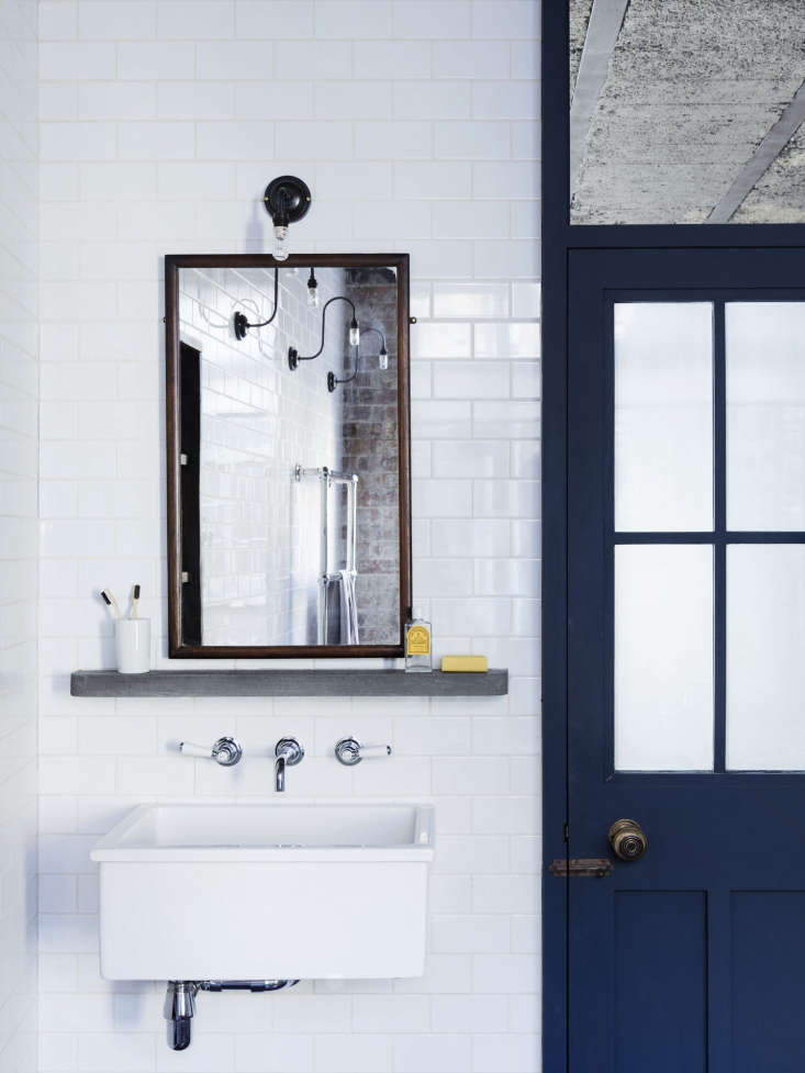 the bathroom is lined in metro white subway tile, which, lewis says, is anothe 17