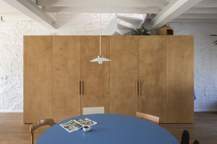 the birch plywood partition rises in front of the stair, and close to the kitch 24