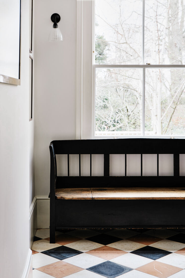 a newly painted antique bench by the front door provides a place to take off sh 28