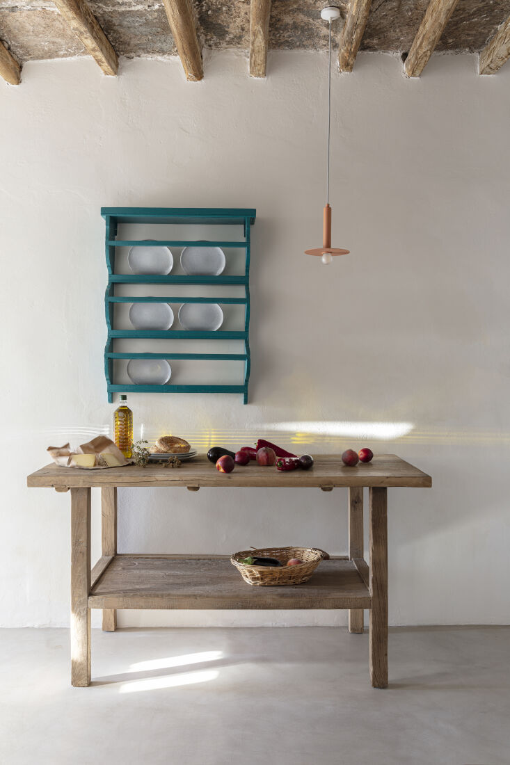 a plate rack hangs over a prep table. for more ideas, see \10 easy pieces: wall 23