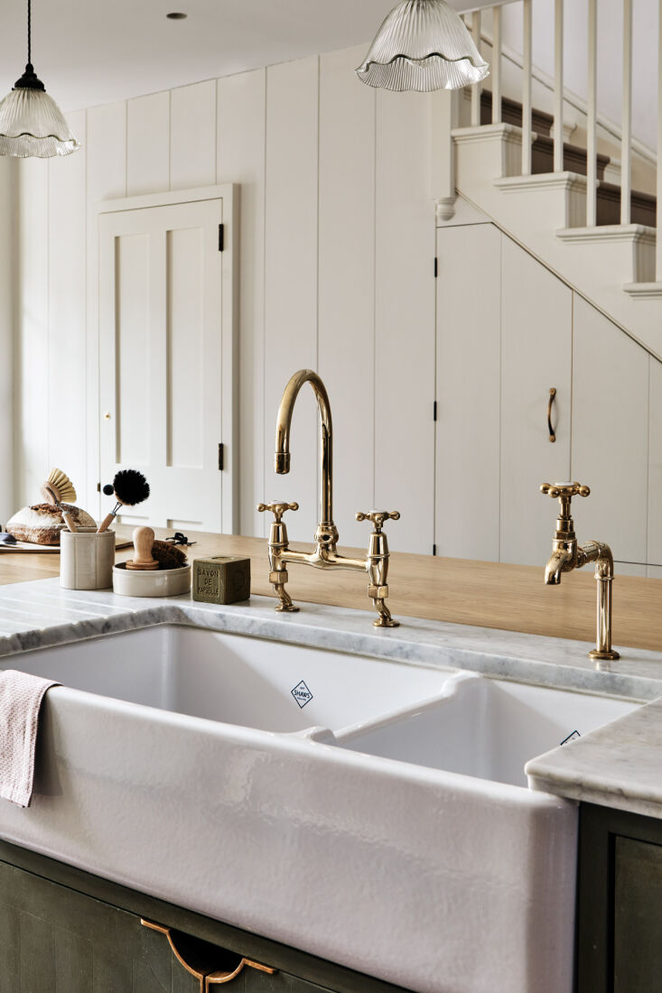 brass faucets from ashton matthews are paired with a shaws edgworth double sink 20