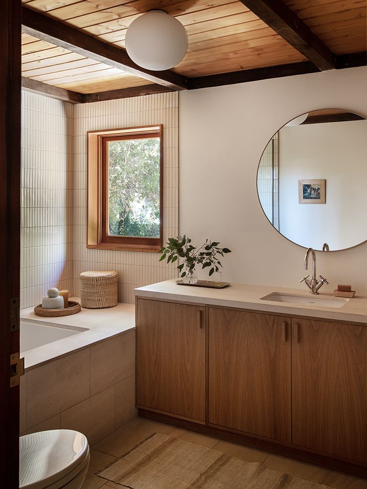 the custom millwork seen on the bath console here, like the work throughout the 18