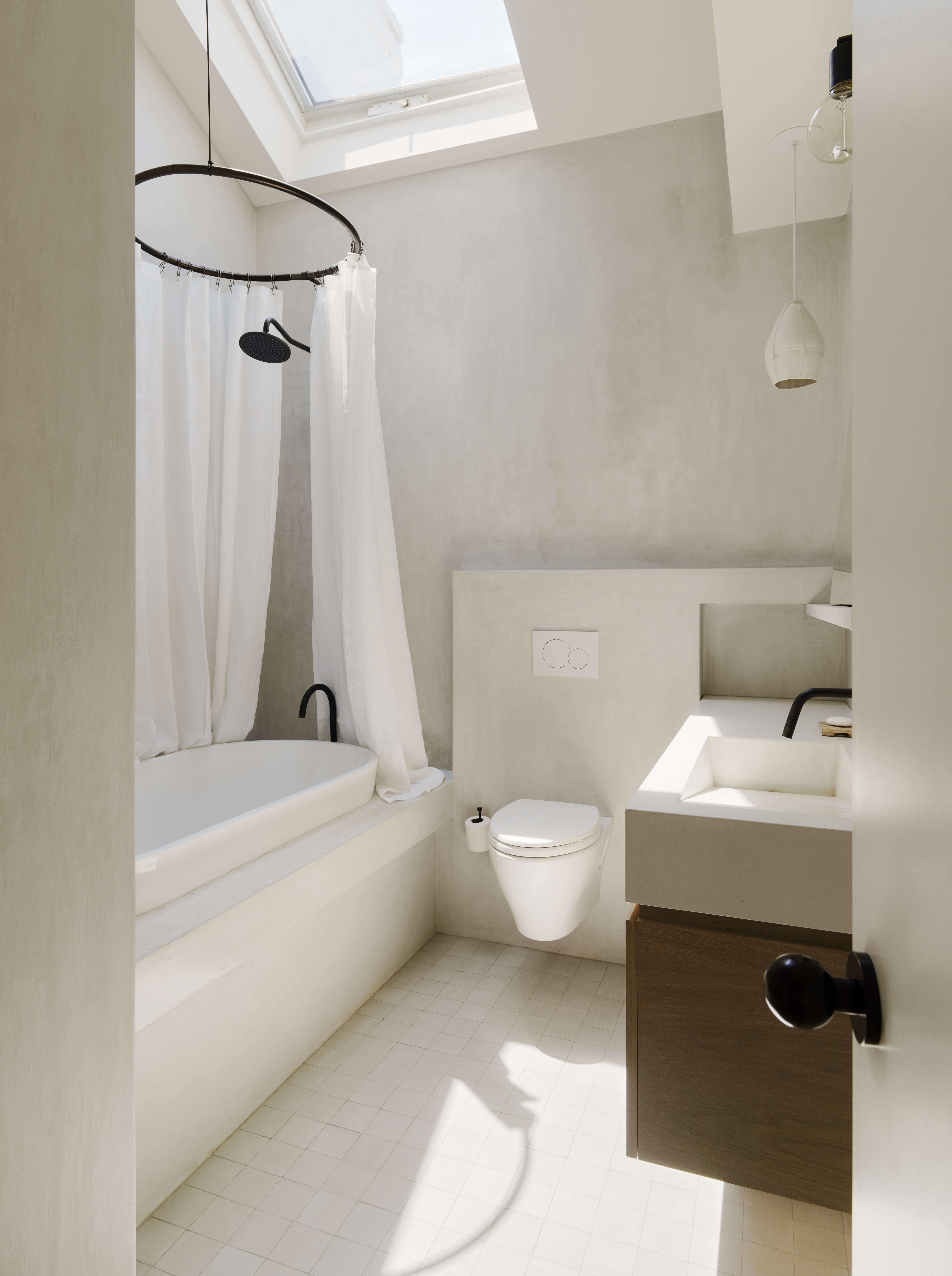 white bathroom in brooklyn apartment with plaster concrete wall finish 17