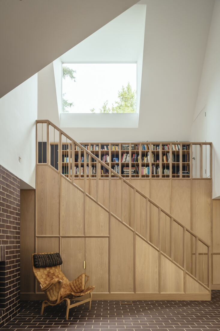 brown brick flooring extends up the length of the fireplace. a bespoke european 23