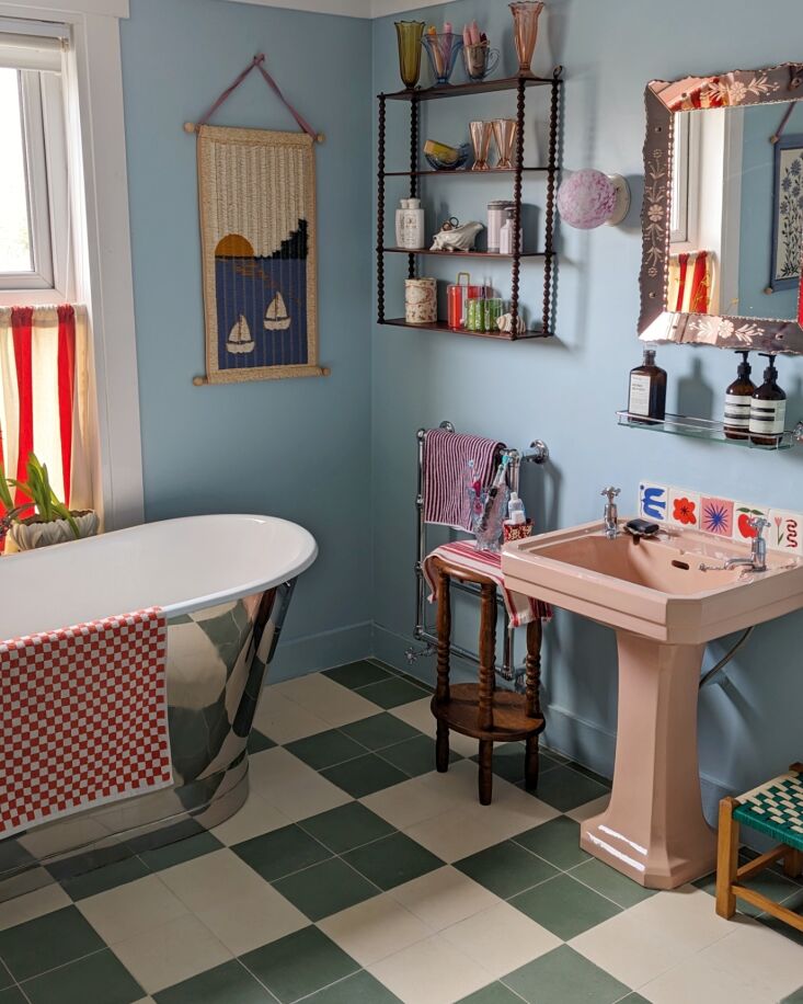 the metallic bathtub is paired with red and white striped and checked linens. p 18
