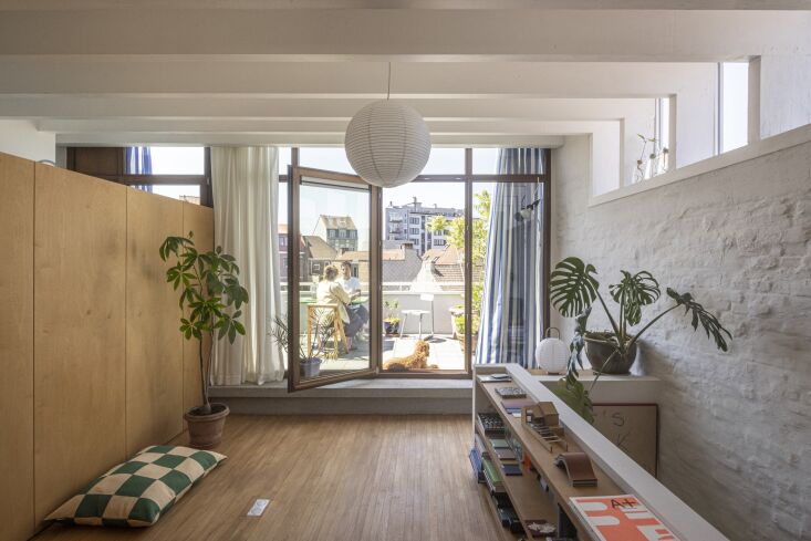 the floor opens to a terrace used as an outdoor dining area. the checked dog pi 35