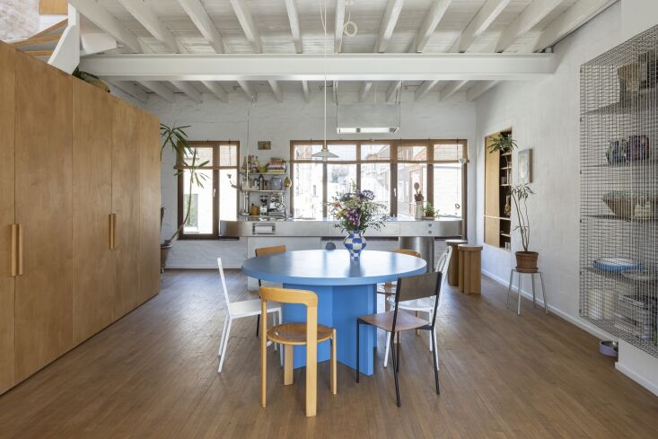 arthur and kelly built their round dining table themselves. its shade of blue r 23