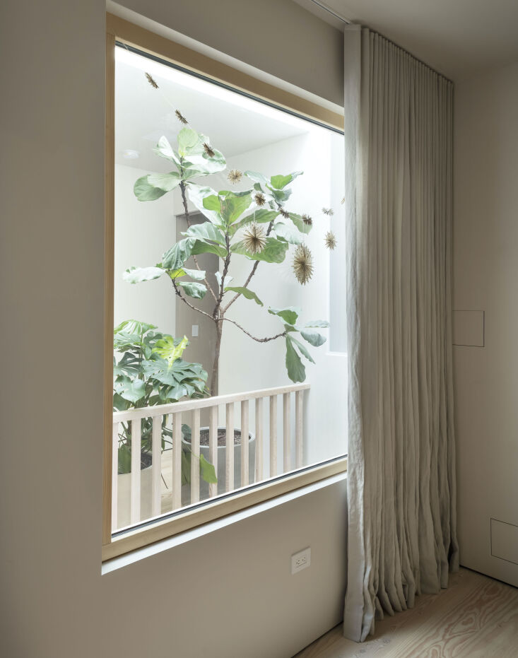 a by mölle linen curtain covers the window wall in the baby\2\17;s room 39