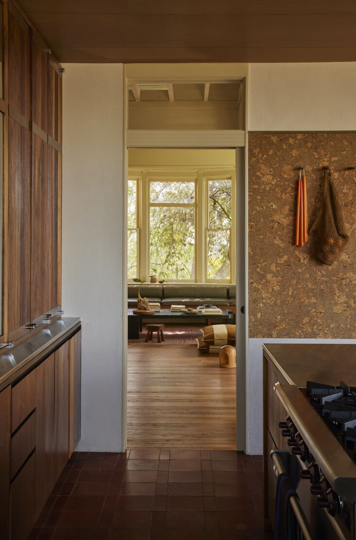 the view from the kitchen toward the living room. the kitchen floor is composed 20