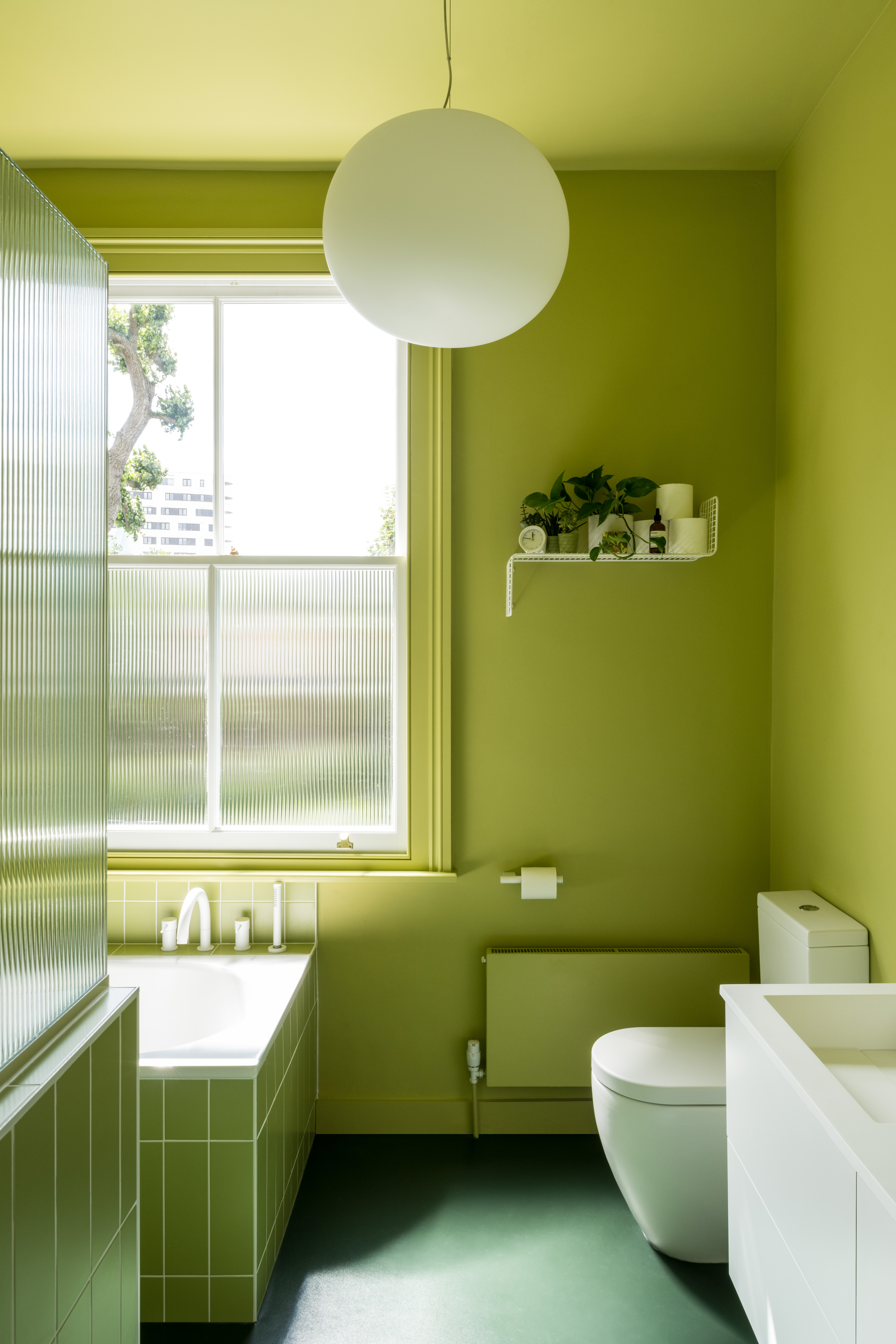 fluted glass in the window and shower of a color drenched bathroom by bradley v 23