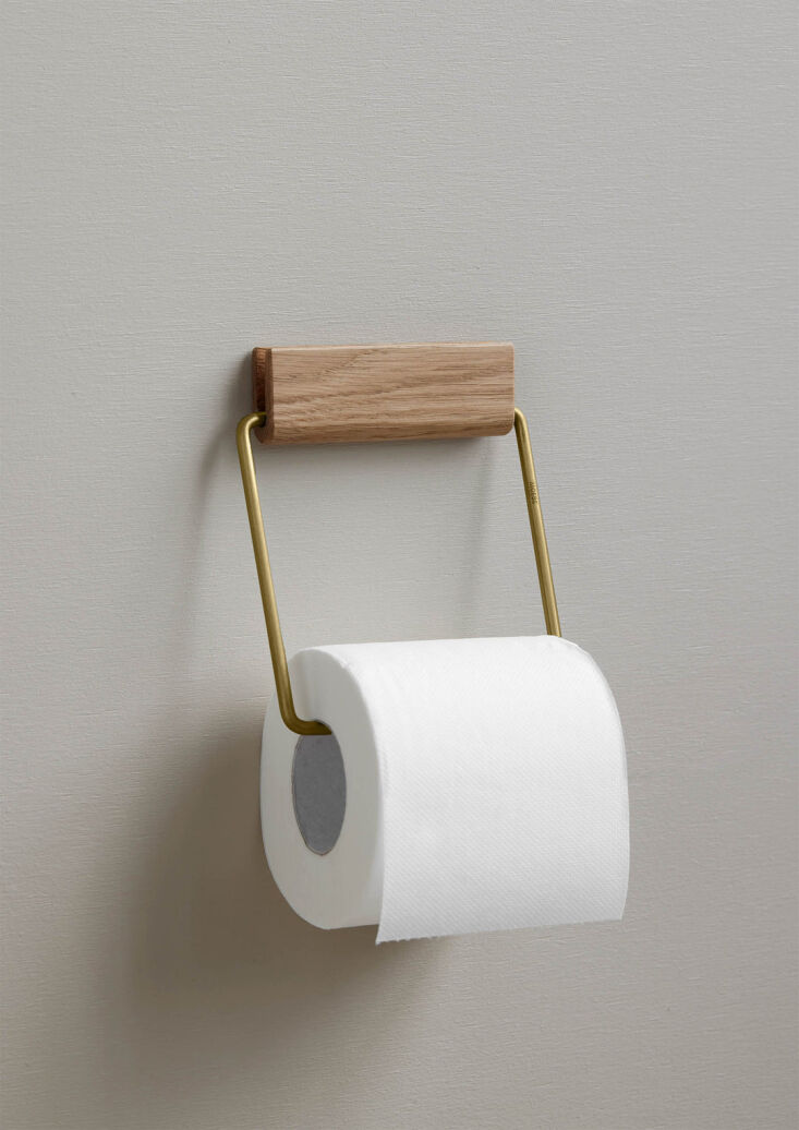 the toilet roll holder in oak and brass. \2\20;the metal wire holds the  18