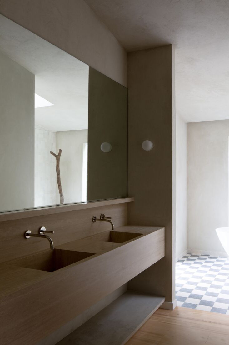 \2\20;a monolithic, sculptural limestone custom vanity invites you into  30