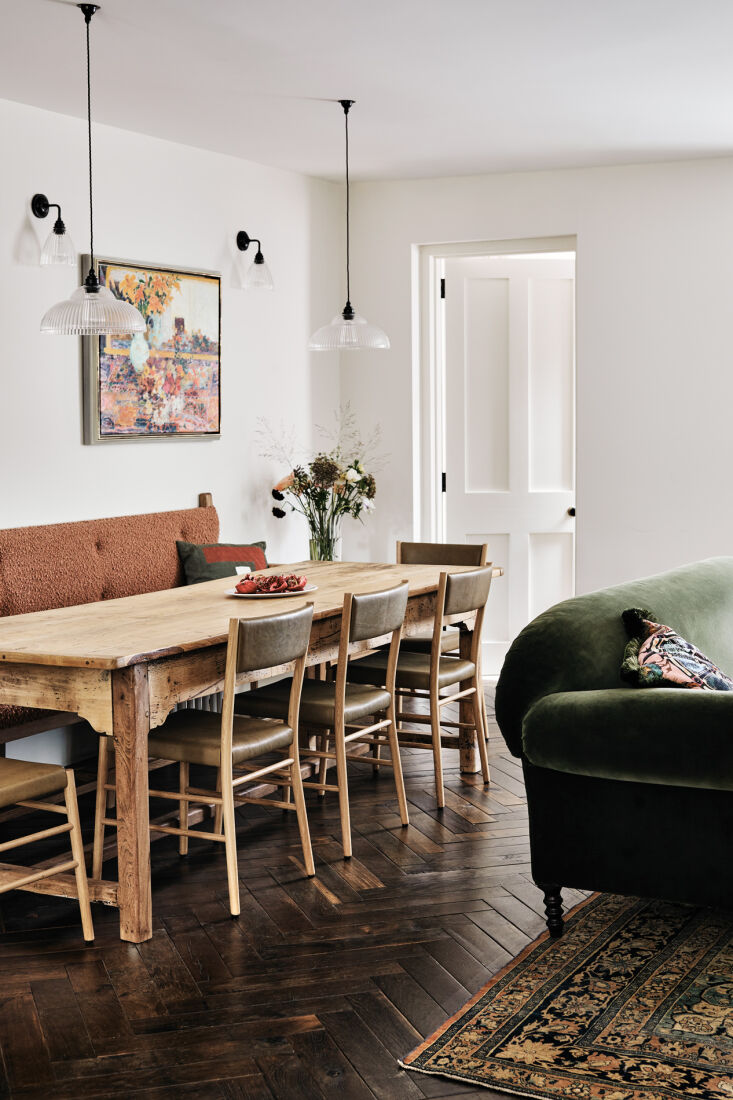 the kitchen flows into a dining living area. the pine table was the clients& 23