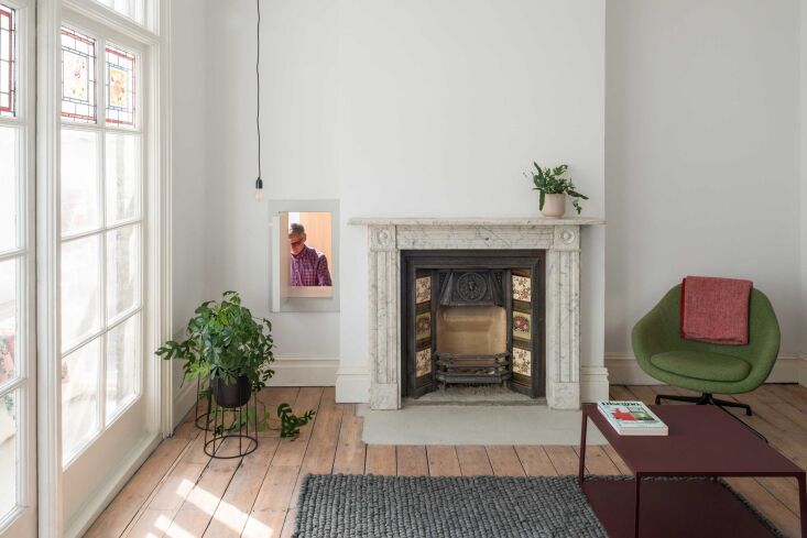 next to the living room fireplace, a hatch opens to the kitchen enabling the pe 26