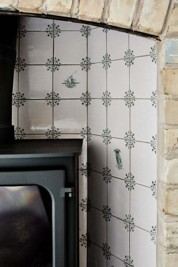 the delft style hearth tiles, in green rather than the traditional blue, are th 25
