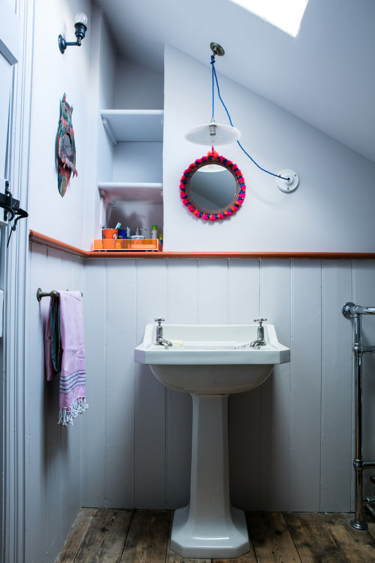 in this white powder room, bursts of color, including a painted ledge that hide 26