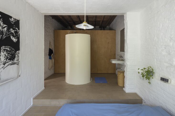 the room steps up to a wardrobe, sink, and capsule shower (made of wood finishe 31